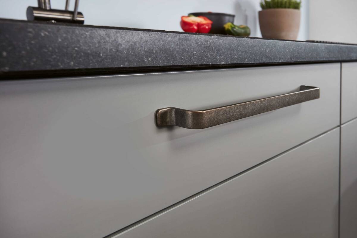 Die Besonderheiten liegen oftmals im Detail: Die kupfernen Griffe der Fronten verleihen der Küche das gewisse Extra. Foto: Studiojeker GmbH. Sabag Biel/Bienne.